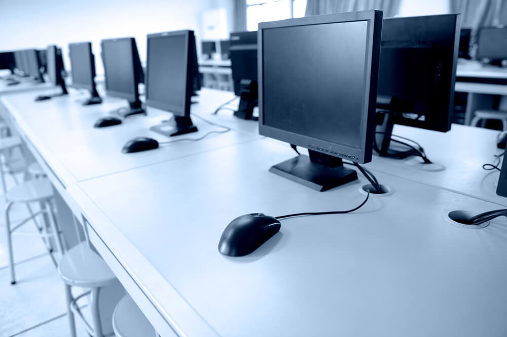 Empty desk with row of monitors