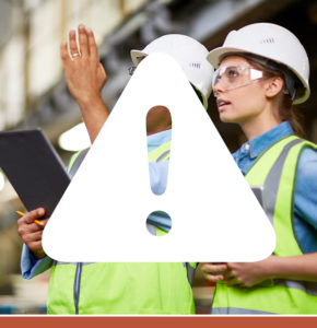 White warning triangle sign icon overlaying a photo of two construction workers discussing