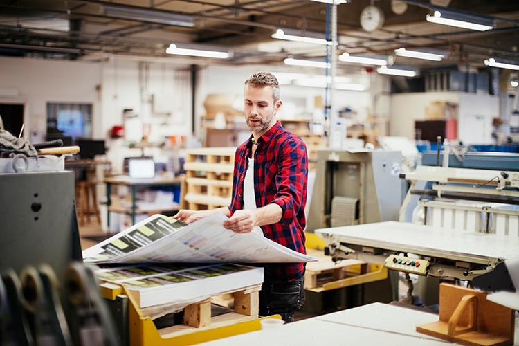 Photo of a man working in printing factory