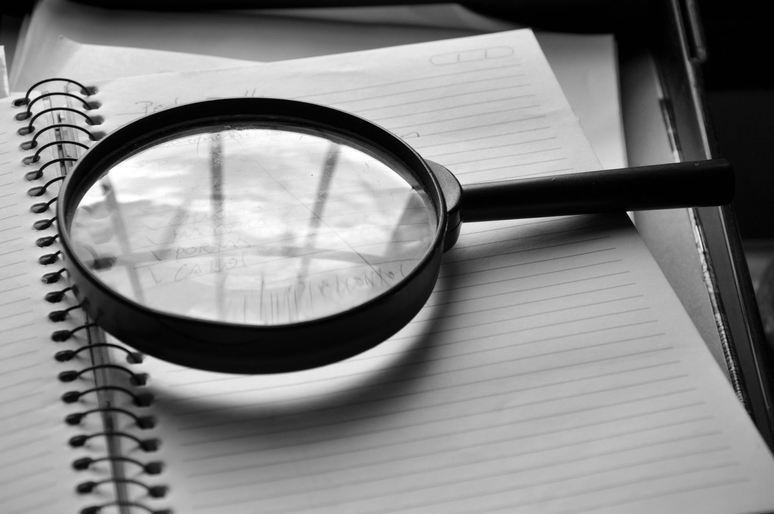 Magnifying glass on a notepad