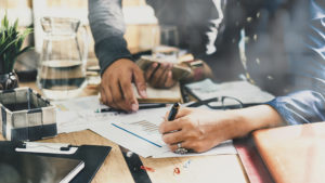 Two people going over graphs