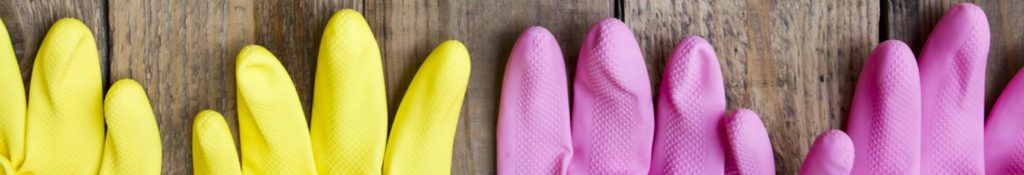 Yellow and pink rubber gloves on wooden table