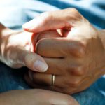 Young hand holding an elderly hand