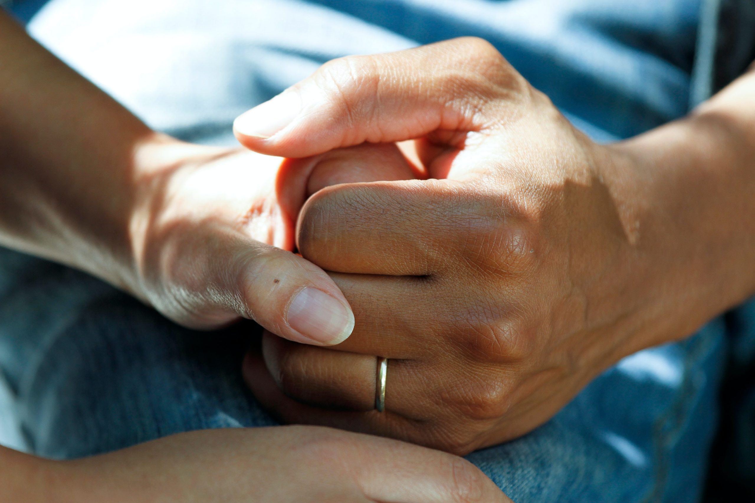 Young hand holding an elderly hand