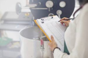 Woman in lab writing on a chart