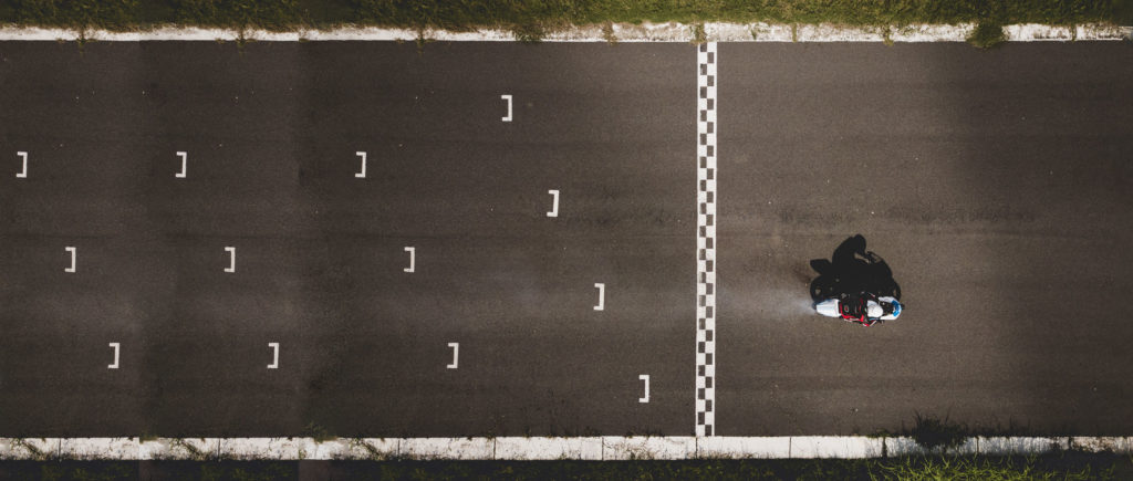 Overhead view of racing track starting grid with motorbike