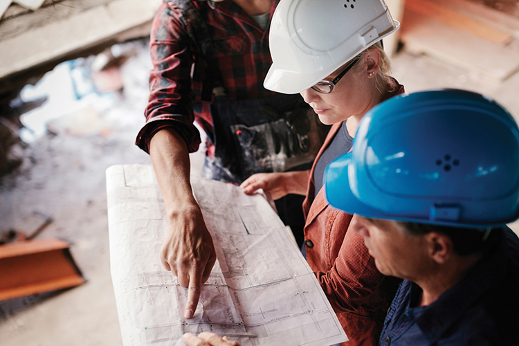 Builders looking over designs