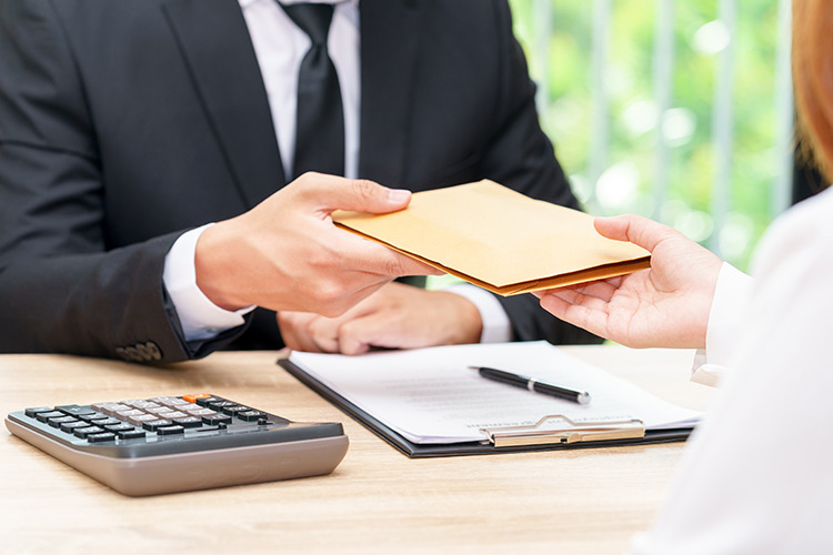 Businessman accepting money in envelope offered by a woman