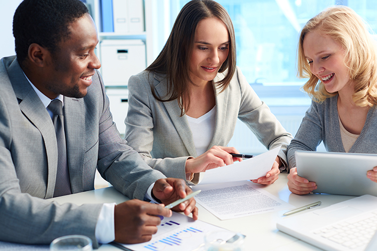 Business people at desk looking at paperwork