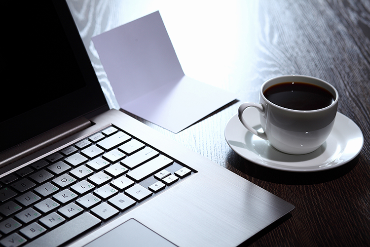 Laptop and tea on a desk