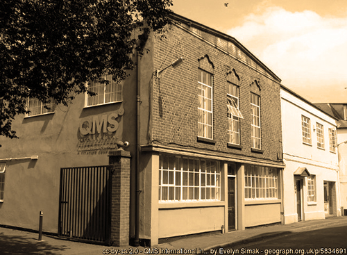 Sepia photo of old building QMS office