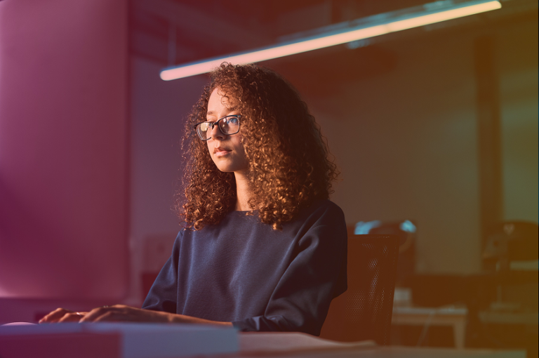 ISO certification woman working at desk, representing quality management standards, documentation, and compliance in business environments.